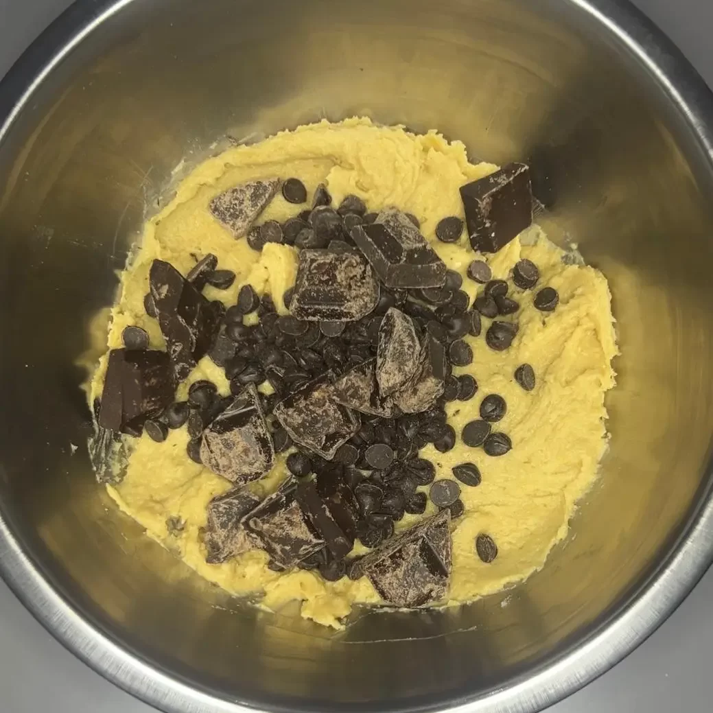 chocolate chip pecan cookie dough in a metallic bowl 
